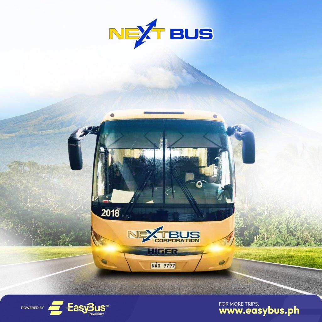 The Mayon Volcano behind a NEXT Bus 2x2 bus